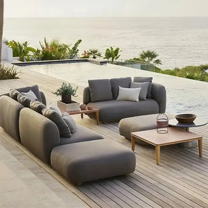 Modern gray outdoor patio sofa set displaying waterproof cushion material and fade resistant fabric up close