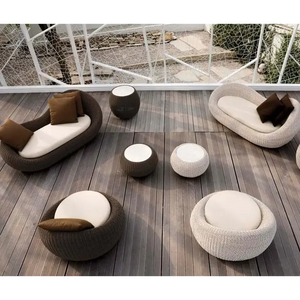 Modern rattan garden sofa set in brown all-weather material, close-up detail of woven texture and craftsmanship.