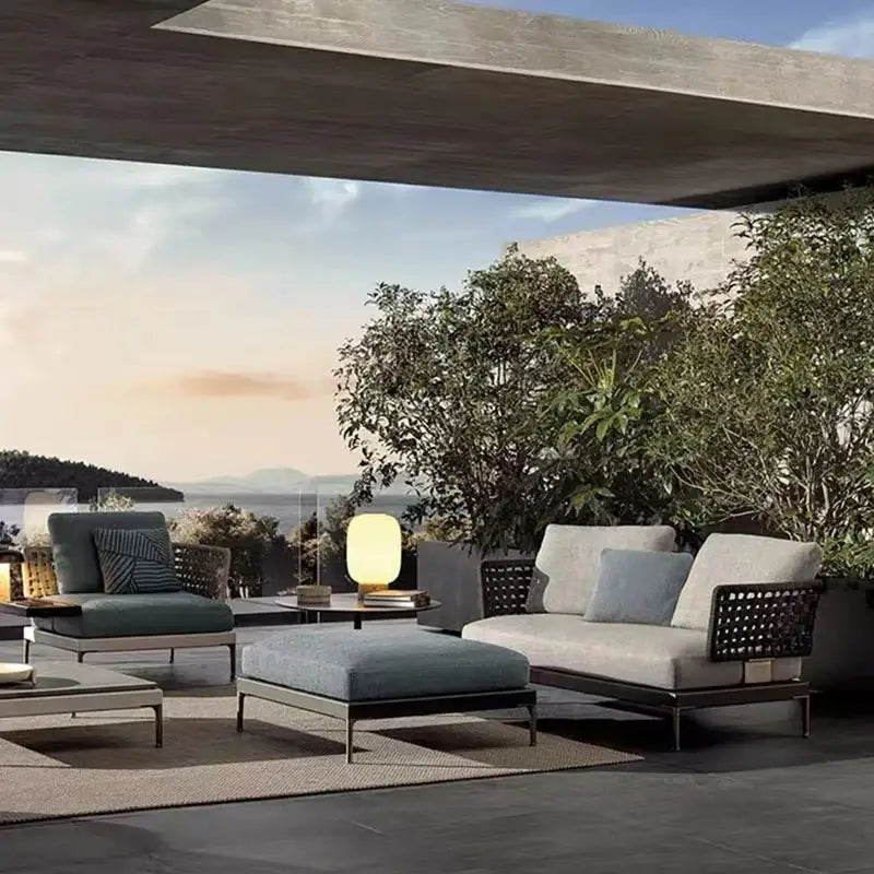Modular L-shaped outdoor rattan sofa set showcasing woven rattan texture and comfortable cushioned seating detail.