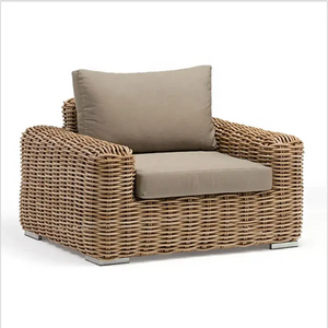 Outdoor wicker rattan sofa set close up showing natural weave texture and luxury garden furniture craftsmanship